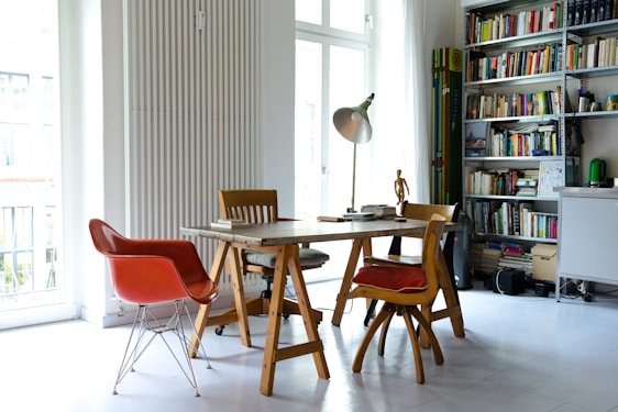 photography of brown wooden dining set near window