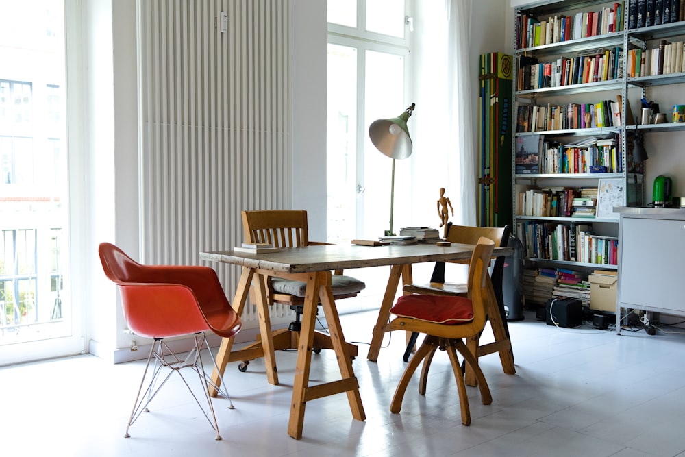 photography of brown wooden dining set near window