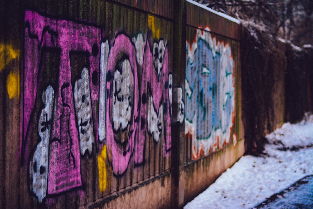 pink and blue graffiti on the wall