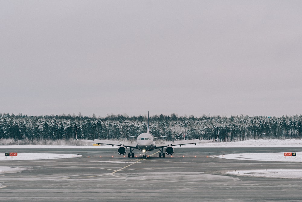 gray airplane on field