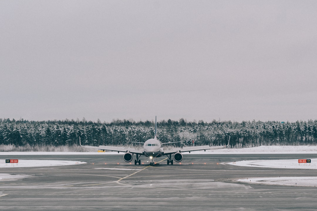 gray airplane on field,