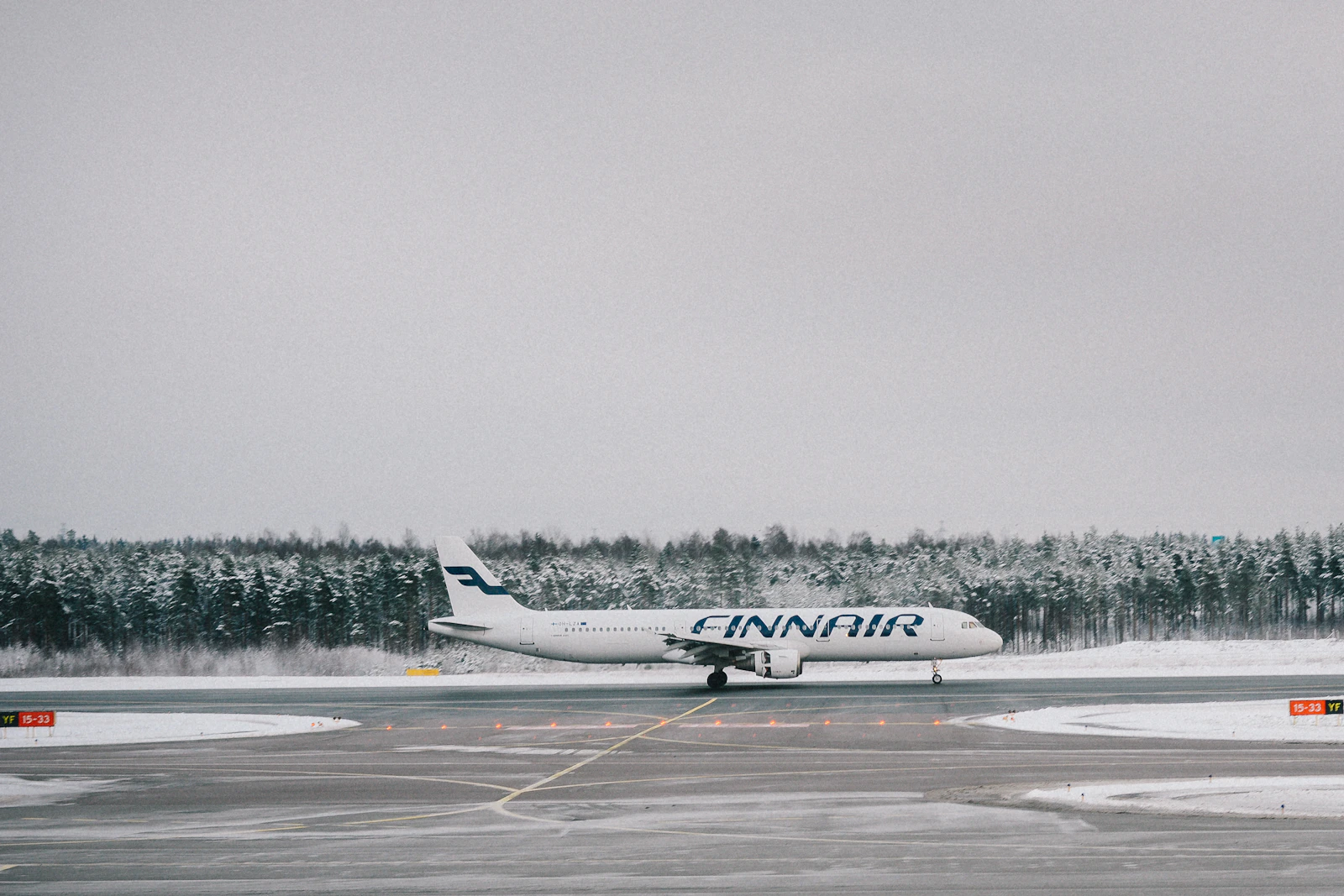 Passenger plane on a snowy runway at Helsinki Airport