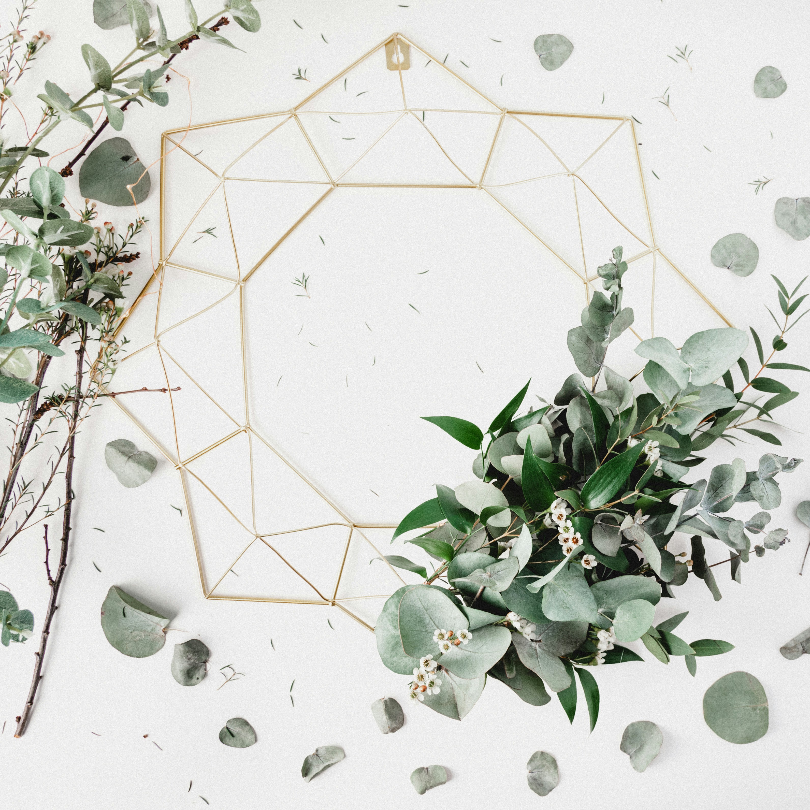 I used some leftover foliage from a photo shoot to style this gold metal geometric wreath from Hobbycraft.