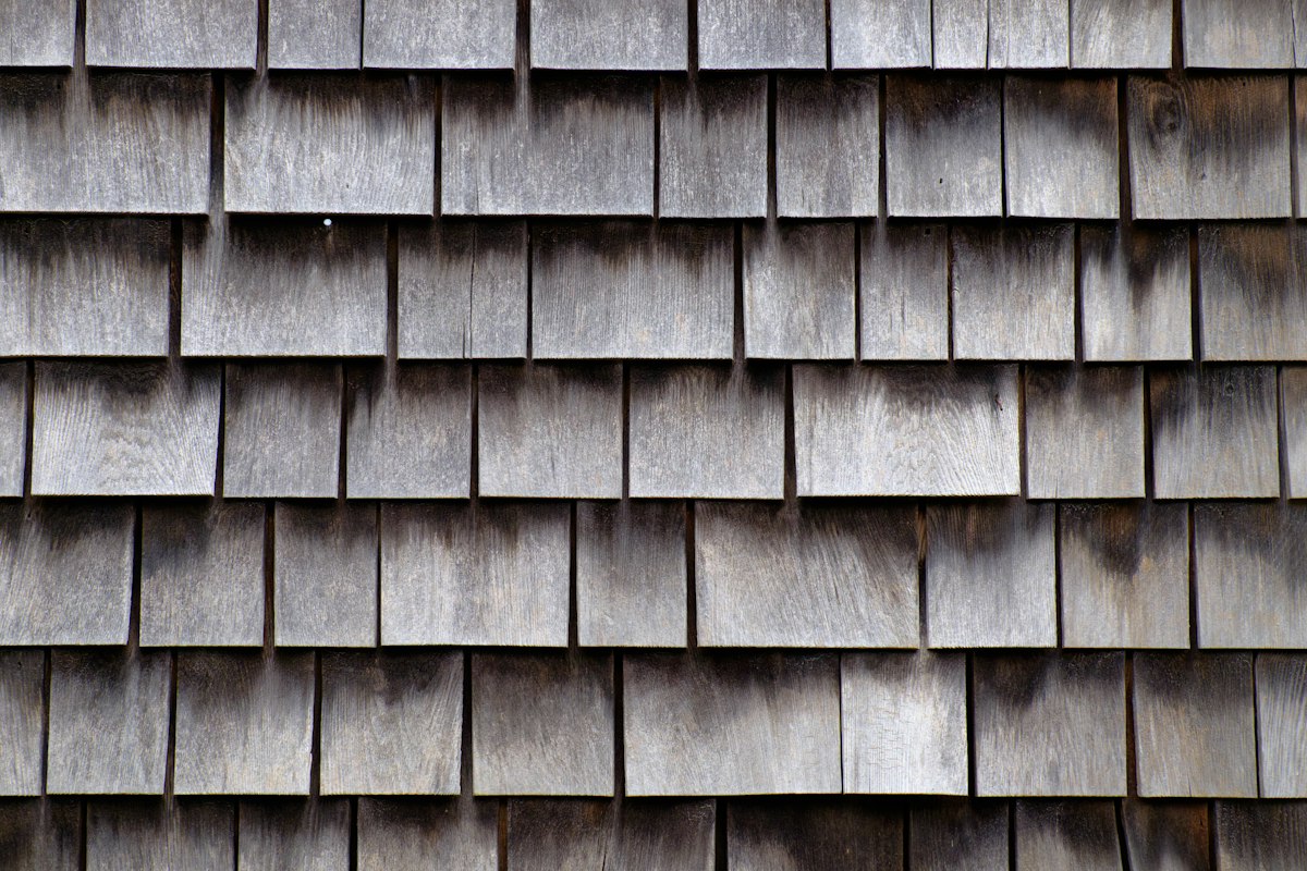 Detail of weathered cedar shake shingles on a home exterior