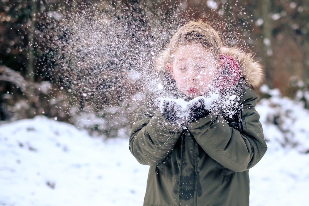 person blowing snow