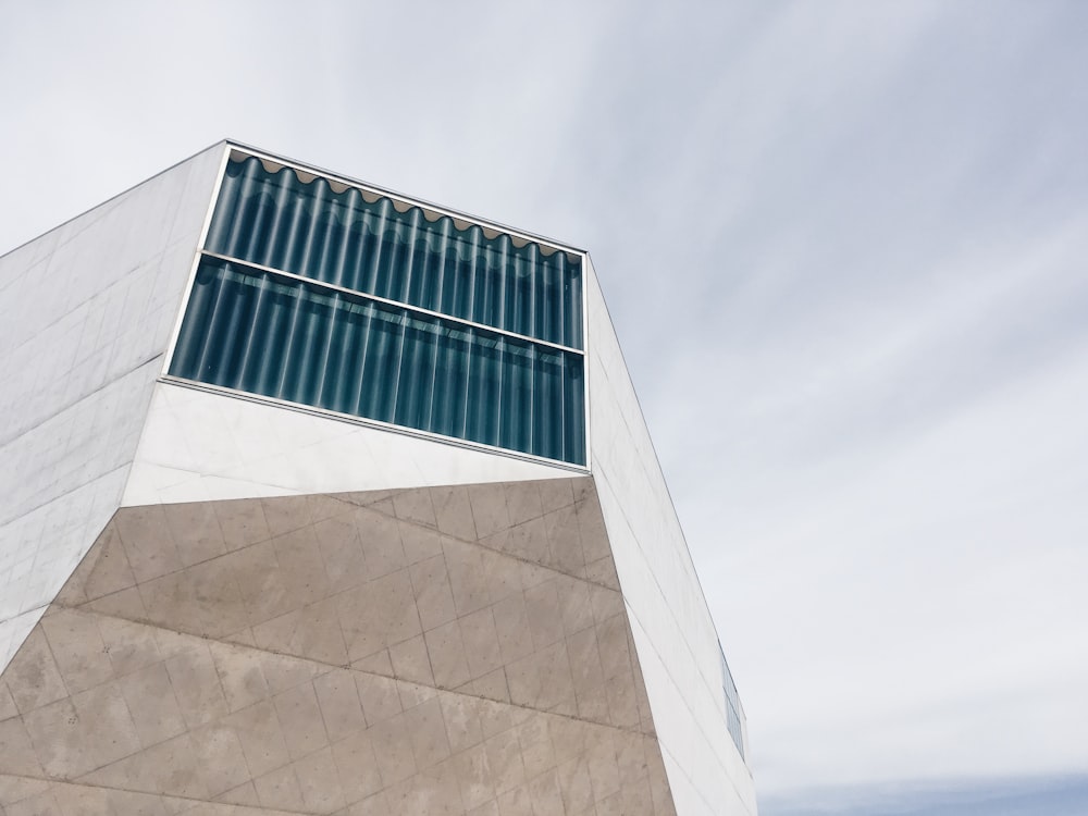 gray concrete building taken under white cloud during daytime