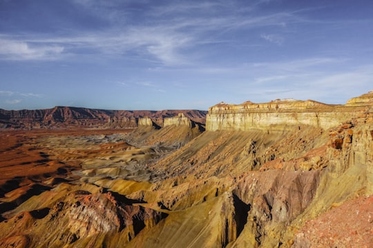 brown rocky mountain under blue sky during daytime in Grand Staircase-Escalante National Monument United States