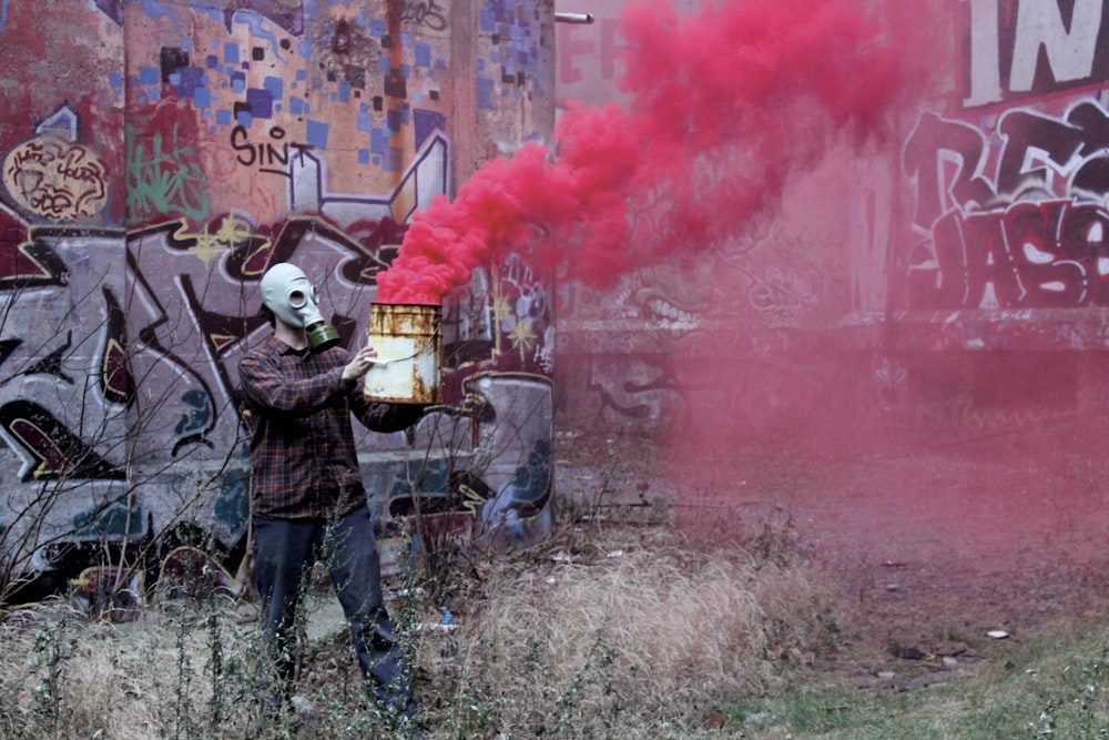 man holding plastic bucket