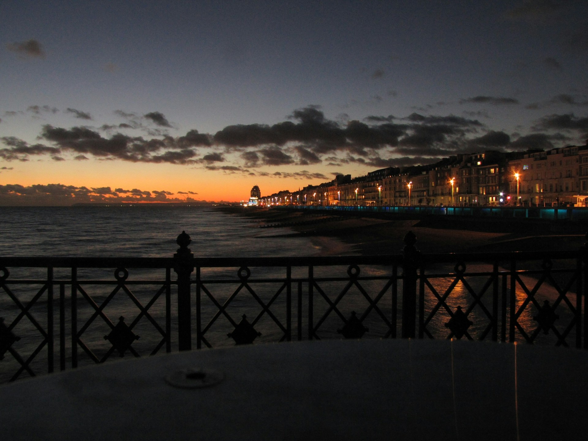 A stunning dusk view of shahrukhz estate along the Ramsgate seafront, showcasing elegant modern architecture against a pastel sky.