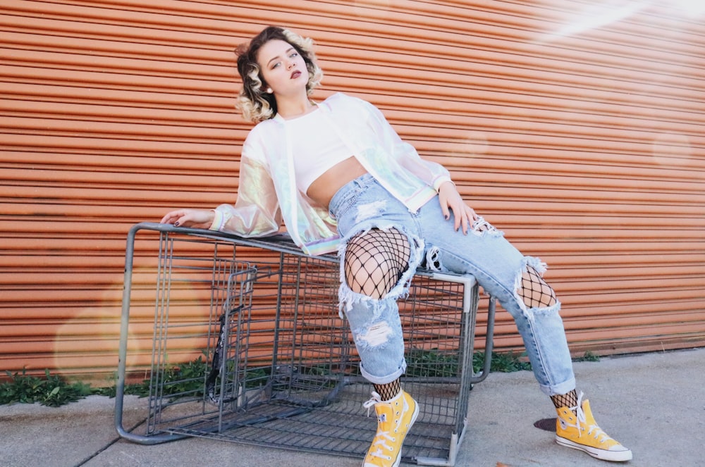 woman posing on grey metal shopping cart