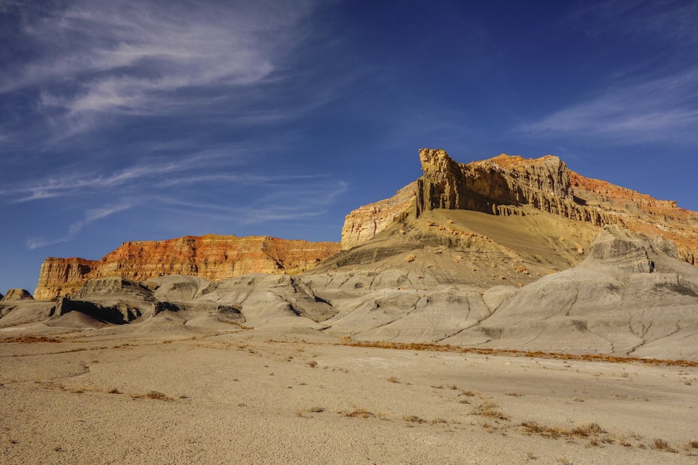 brown cliff near desert at daytime