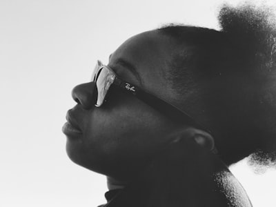 person wearing ray-ban sunglasses new orleans google meet background