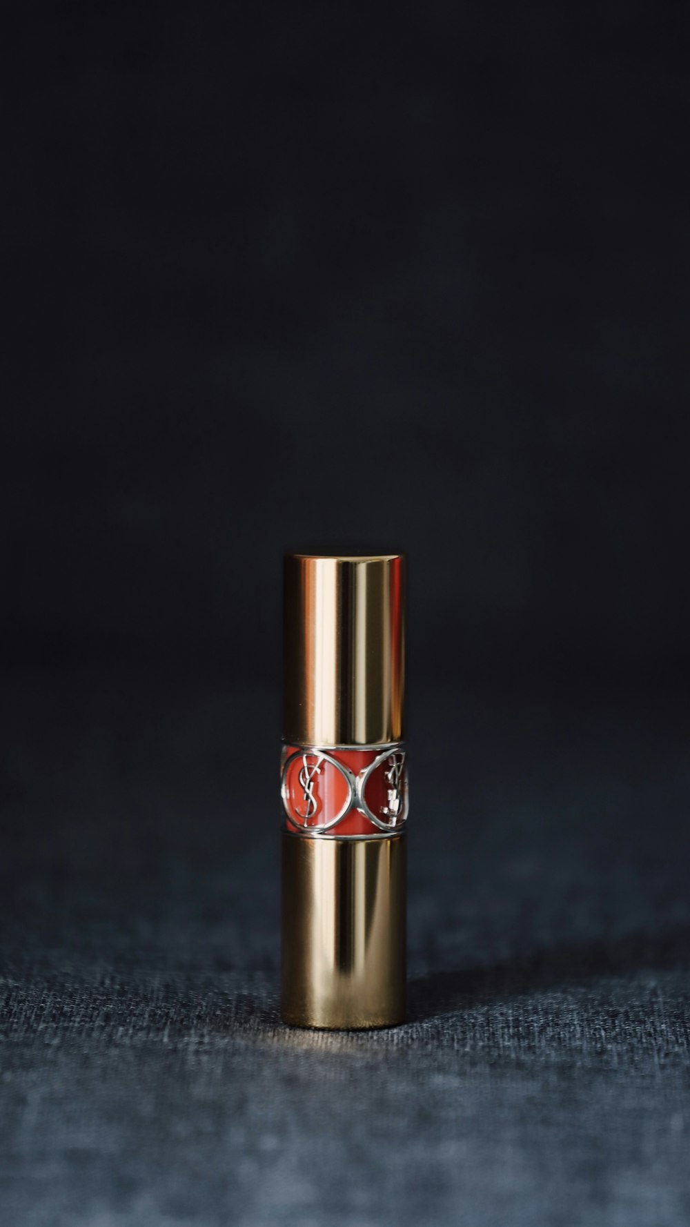 lipstick bottle on gray surface
