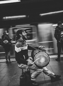 man playing drum in subway