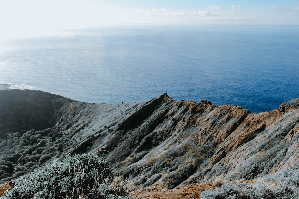 body of water beside mountain