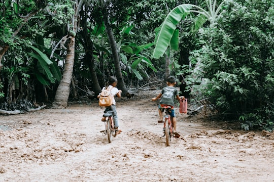 two person riding on bicycle during daytime in Paoy Paet Cambodia