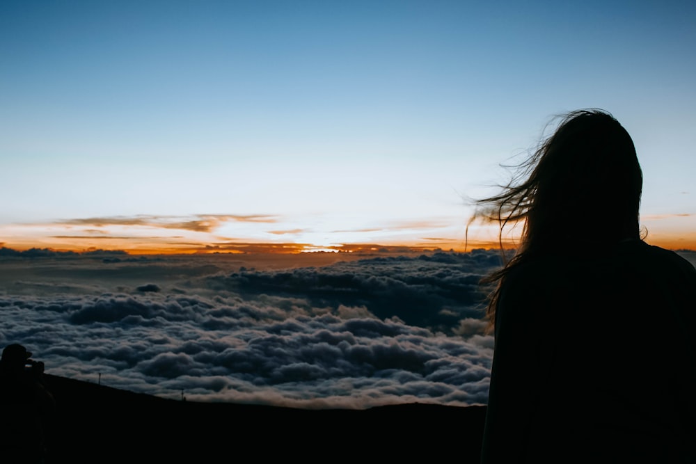 person overlooking clouds