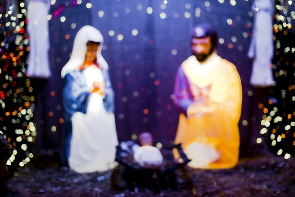 a nativity scene of a manger scene with a baby jesus in a man