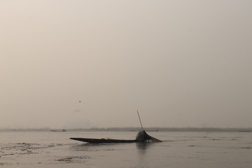 ship sinking in body of water