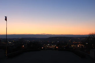 A city skyline at dusk with American flag colors subtly overlaid.