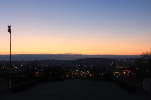 A city skyline at dusk with American flag colors subtly overlaid.