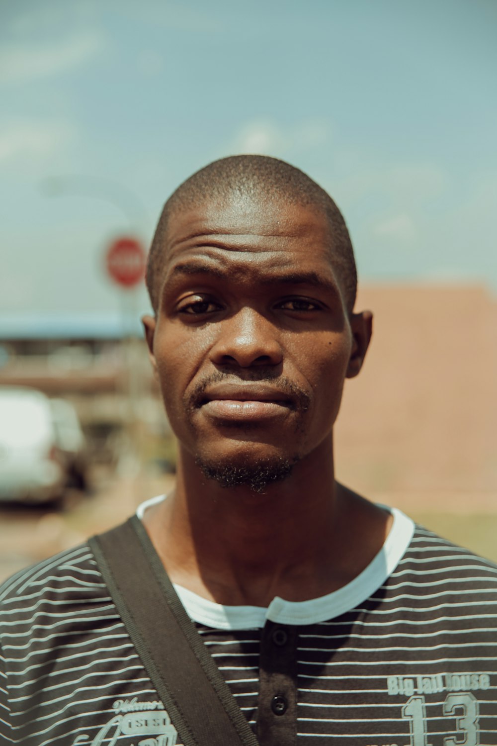 shallow focus photography of man in black and white striped top