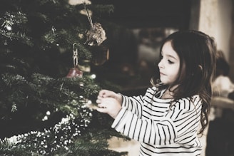 girl decorating the Christmas tree