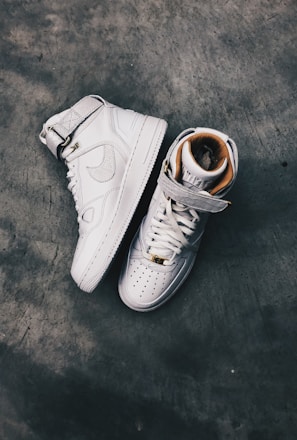 pair of white Nike high-top shoes