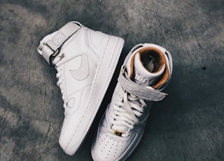 pair of white Nike high-top shoes