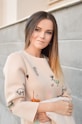 woman in beige and green long-sleeved shirt