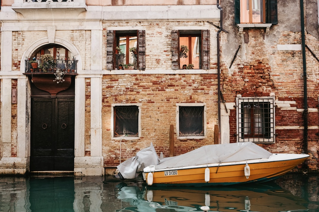 orange boat in front of building