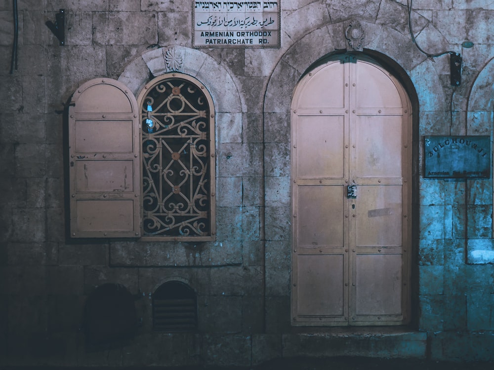 brown steel door between concrete wall