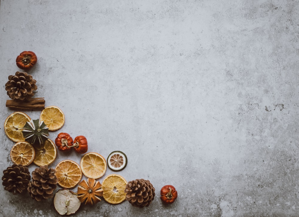 top view photo of brown pinecone and sliced fruit