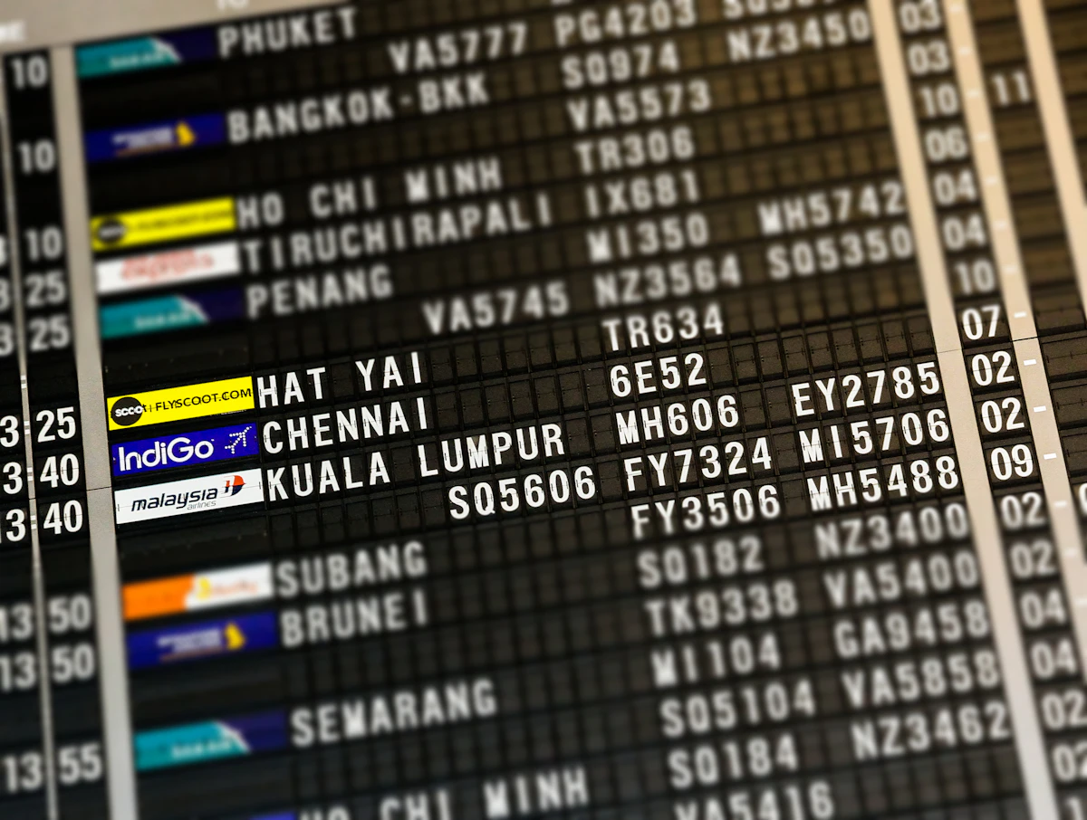 An airport flight information board listing departures