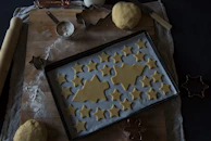 A cozy kitchen scene with baking tools, flour dust, and a partially decorated cake in progress.