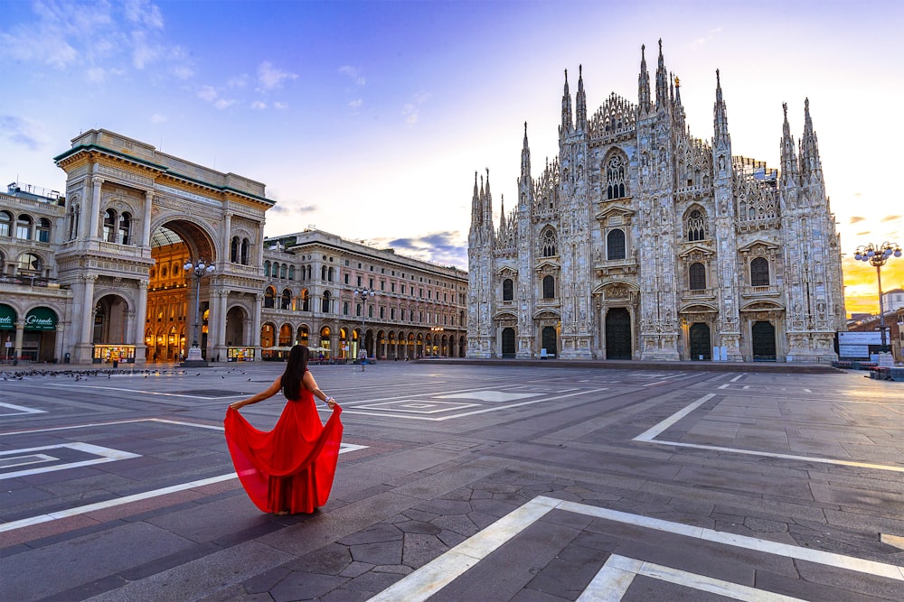 woman wearing red gown facing at cathedral