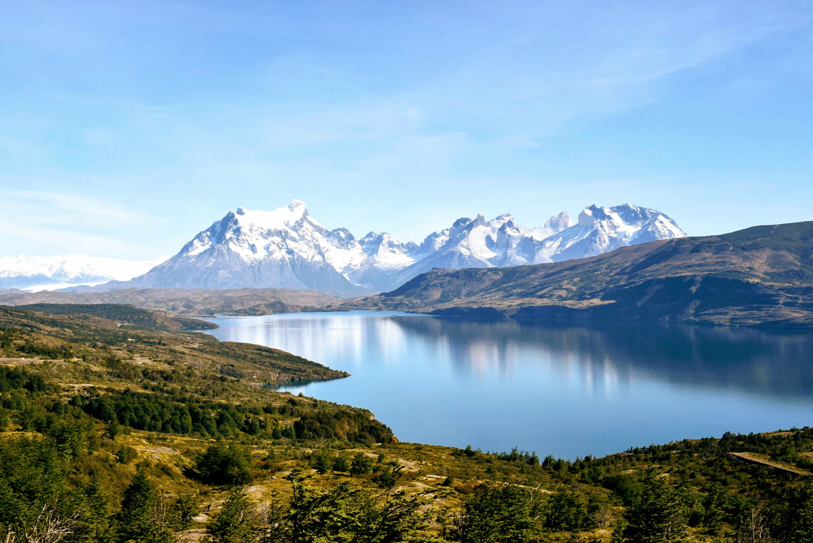 Dramatic mountain peaks of Torres del Paine rising above clouds in Patagonia Chile South America