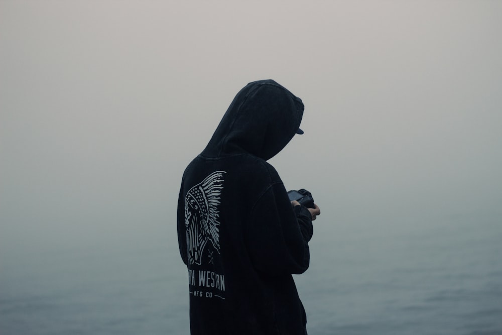 photo of man person wearing black hoodie
