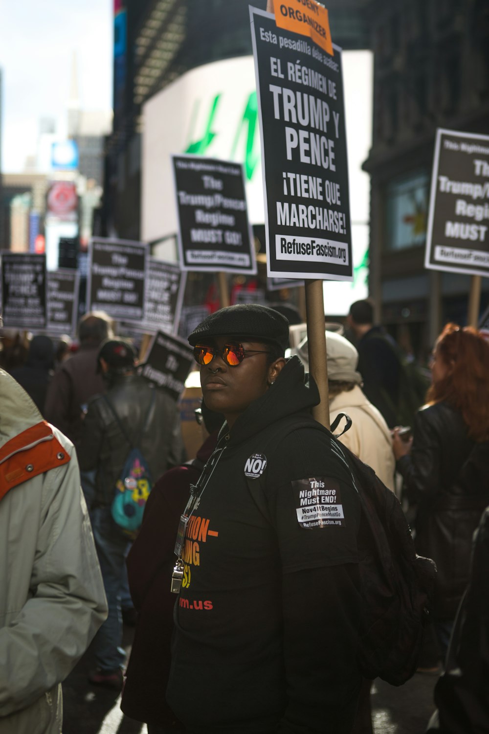 man standing near protesters