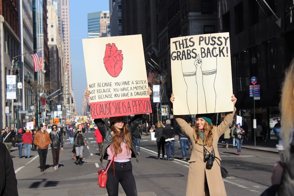 two women raising banners