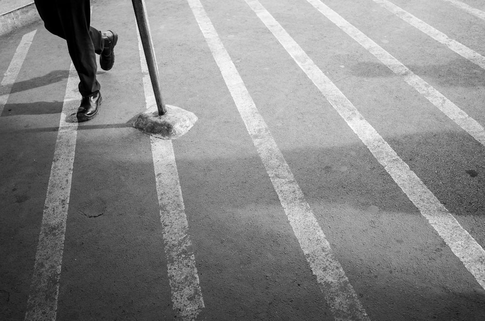 grayscale photo of man wearing lace-up shoe