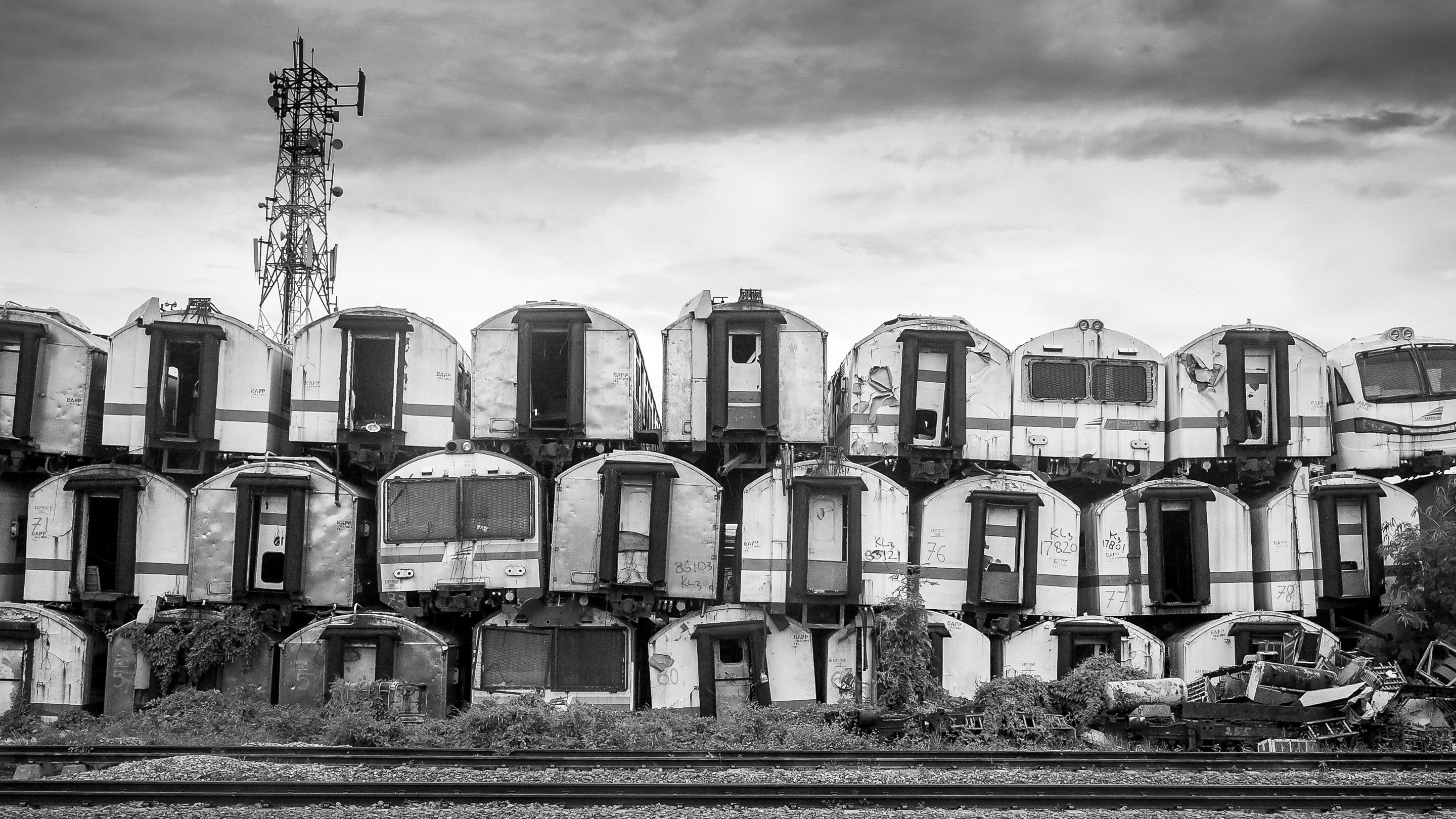 grayscale photography of piling of container vans