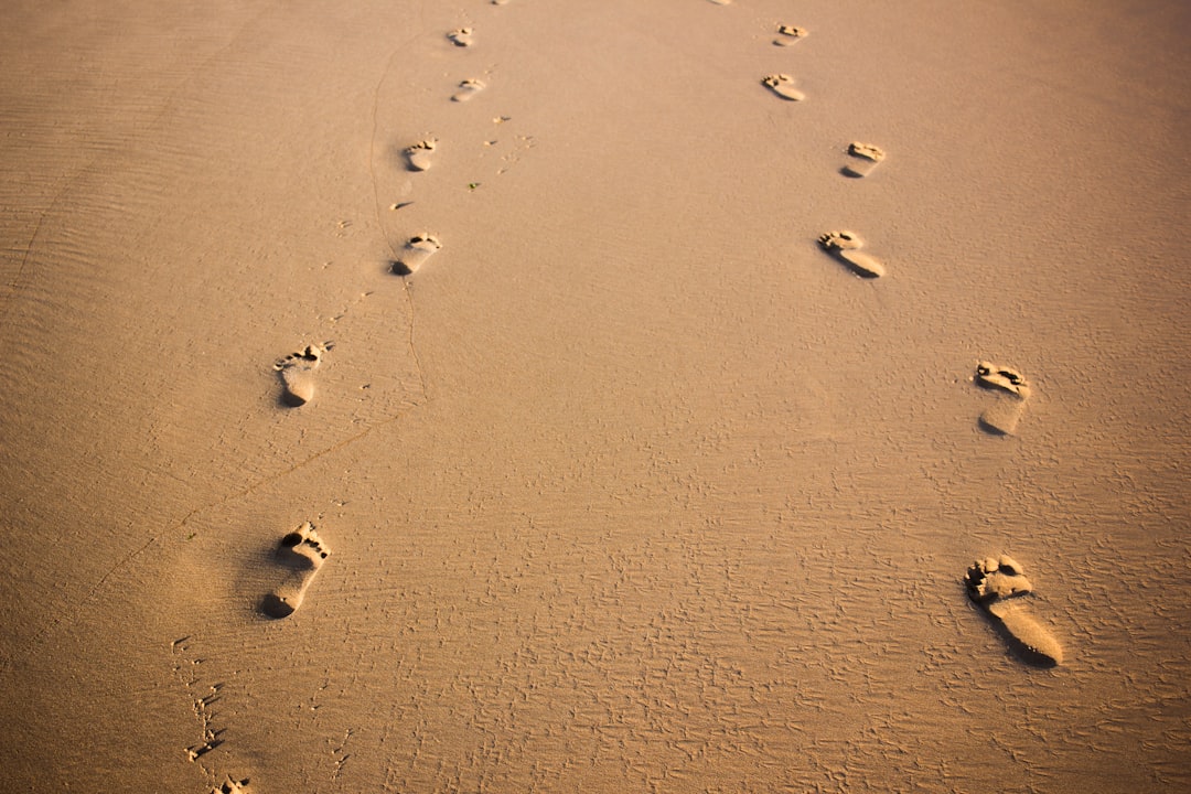 foot prints on brown sand