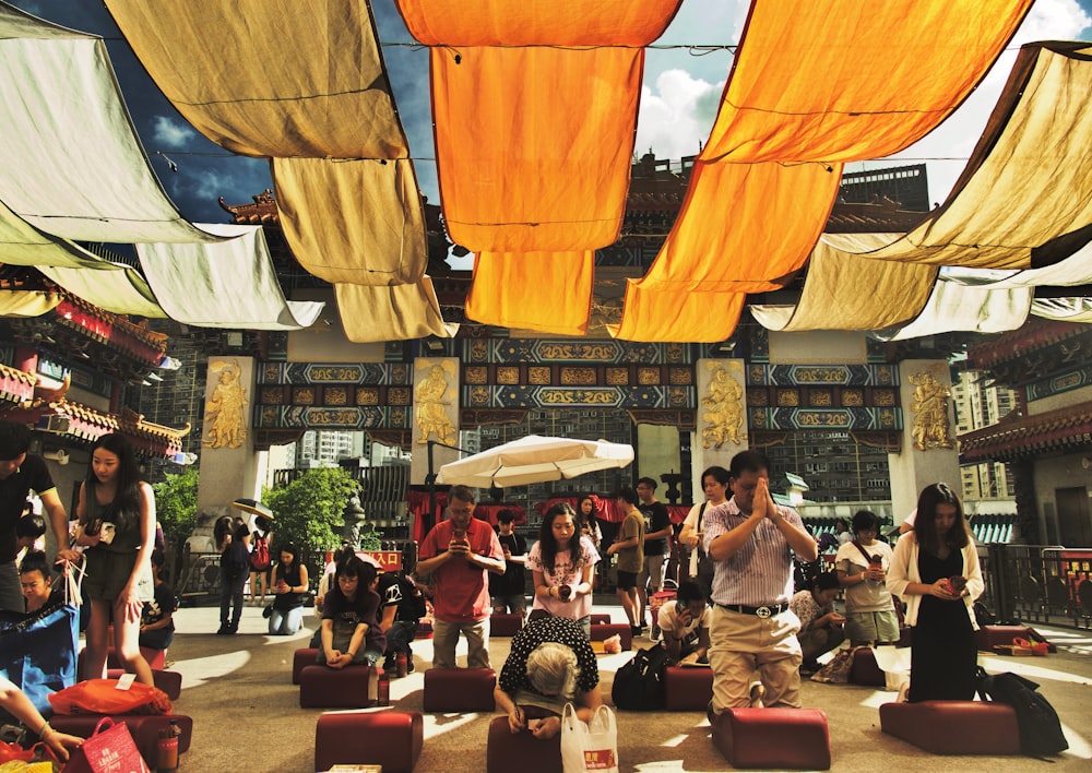 people kneeling on red cushion