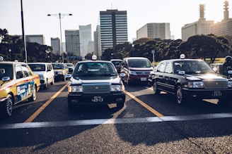 A busy street scene with various taxis in motion.