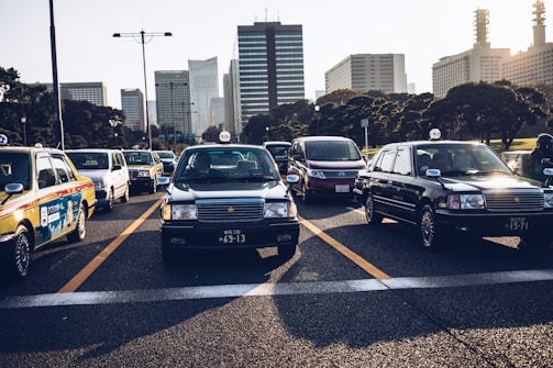 A busy city street filled with various taxis.