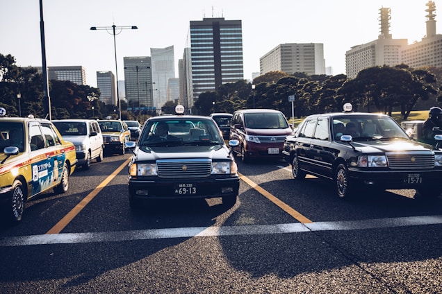 A busy city street with taxis waiting for passengers.
