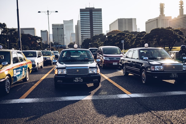 A modern taxi on a busy city street.