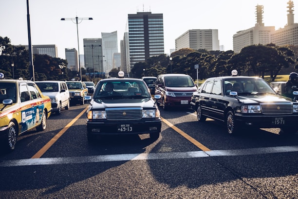 A busy urban street with multiple taxis waiting near a downtown business area.