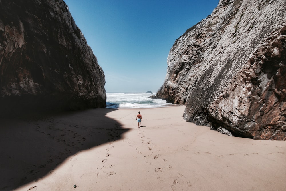 person standing on beige sand during daytime